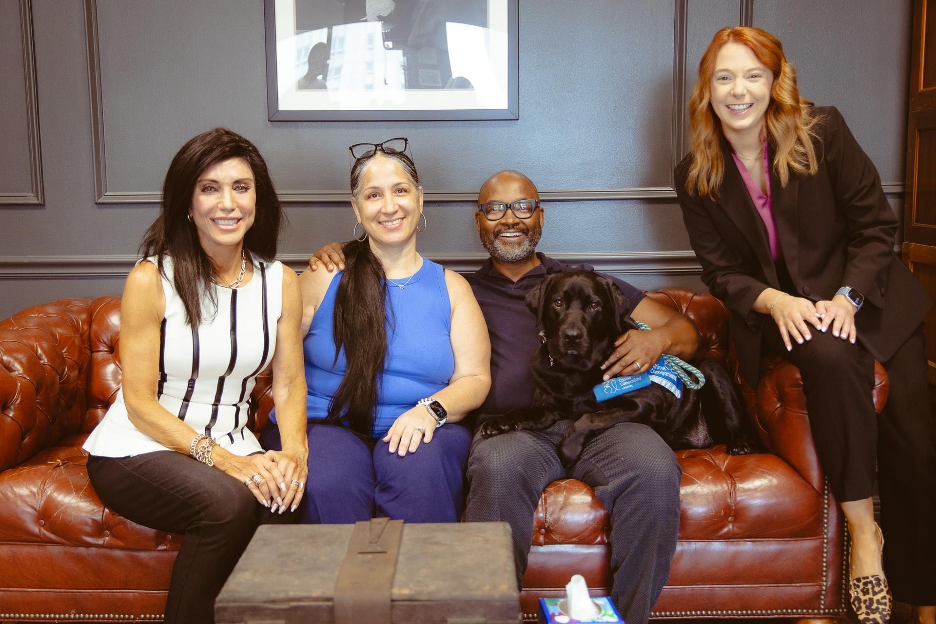 Staff of the Orleans Parish District Attorney's Office with the office's courthouse facility dog.